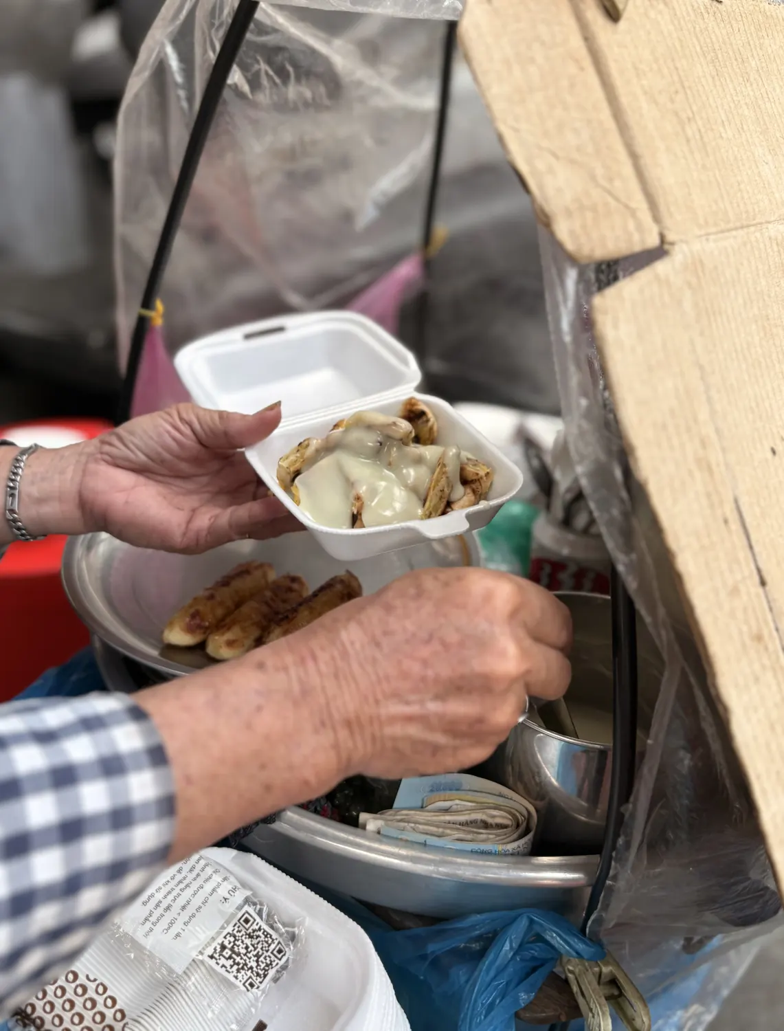 Local street-food vendor serving a snack in Chợ Lớn