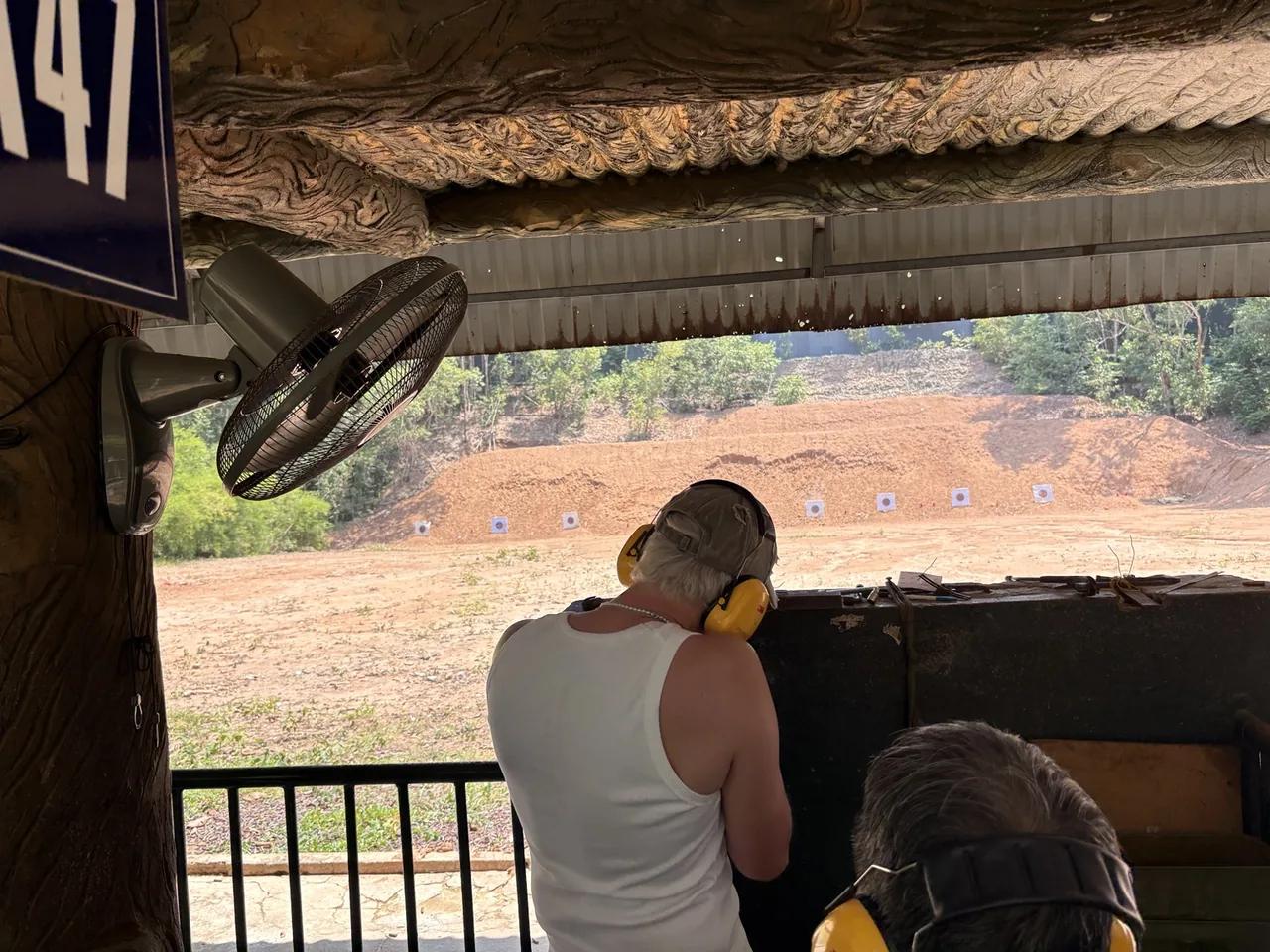 A visitor wearing hearing protection at the optional Cu Chi shooting range