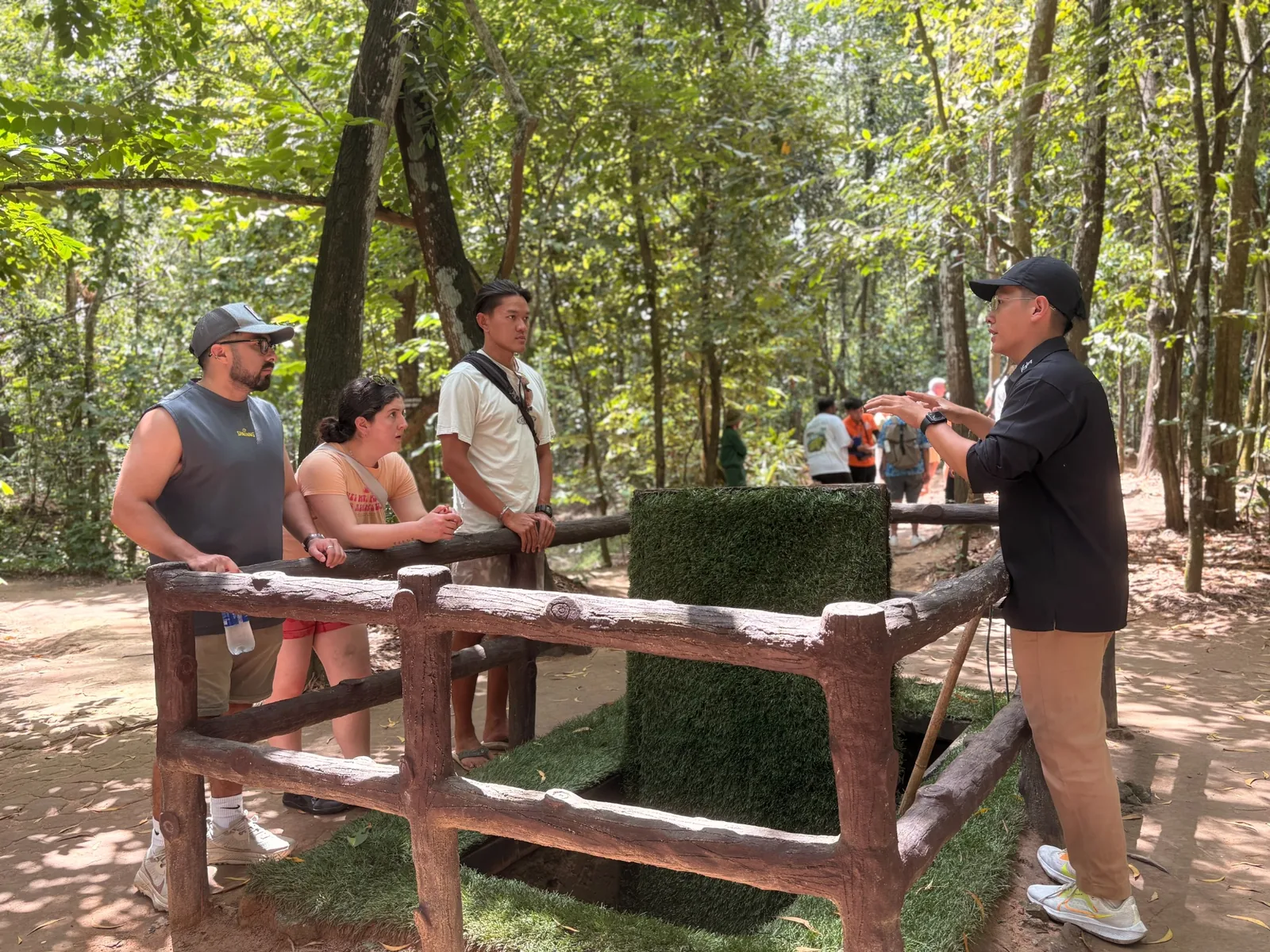 A local guide with guests at Cu Chi